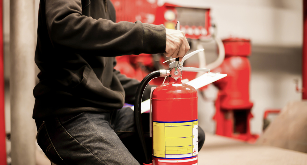 The red fire extinguisher is ready for use in case of an indoor fire emergency TechMotion Systems TechMotion Systems The Importance of Fire Protection Systems